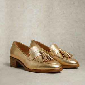 Women's gold metallic loafers with tassels